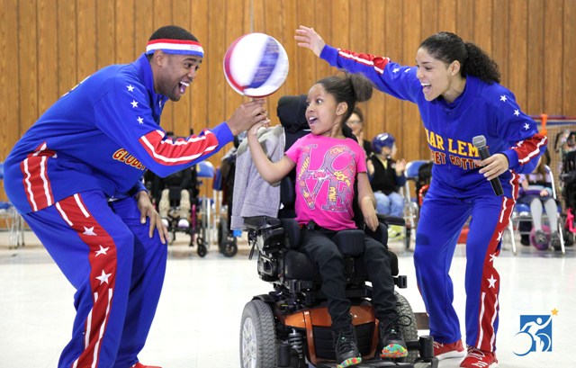 Harlem Globetrotters play basketball with Henry Viscardi School students.
