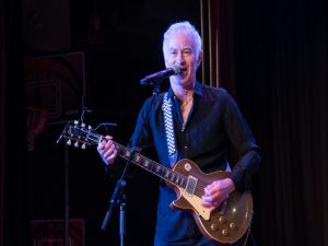 John McEnroe playing the guitar